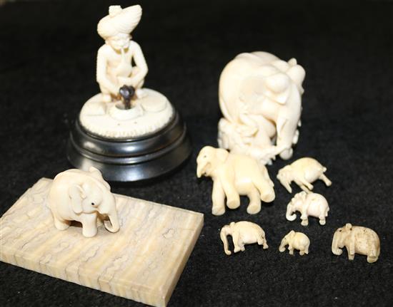 A group of Indian ivory and bone figures of elephants and a snake charmer